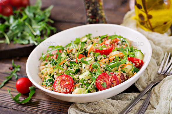 Salads with quinoa, arugula, radish, tomatoes and cucumber - Stock Photo - Images