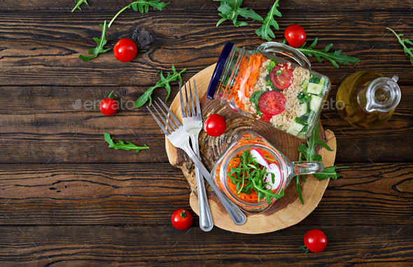 Salads with quinoa, arugula, radish, tomatoes and cucumber - Stock Photo - Images
