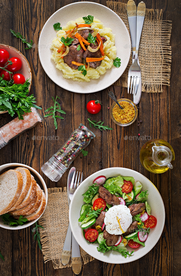 Fried chicken liver with vegetables and garnish of mashed potatoes. - Stock Photo - Images