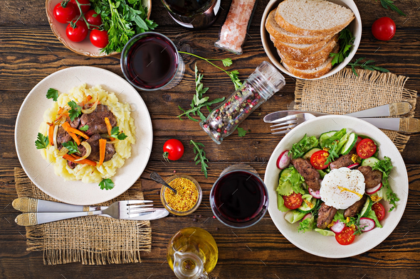 Warm salad from chicken liver, radish, cucumber, tomato and egg poached. - Stock Photo - Images