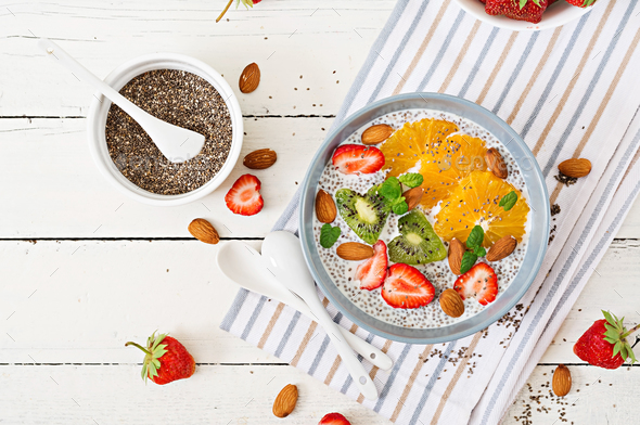 Vegan almond milk chia seeds pudding with strawberries, orange and kiwi - Stock Photo - Images