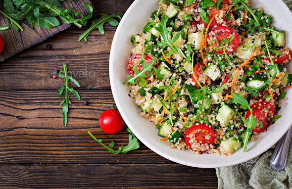 Salads with quinoa, arugula, radish, tomatoes and cucumber - Stock Photo - Images