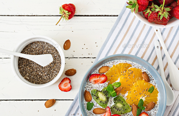 Vegan almond milk chia seeds pudding with strawberries, orange and kiwi. - Stock Photo - Images