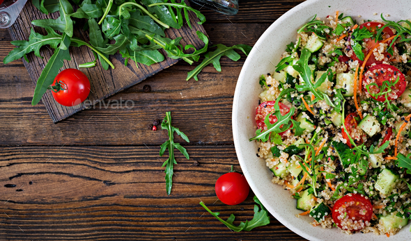 Salads with quinoa, arugula, radish, tomatoes and cucumber in bowl - Stock Photo - Images