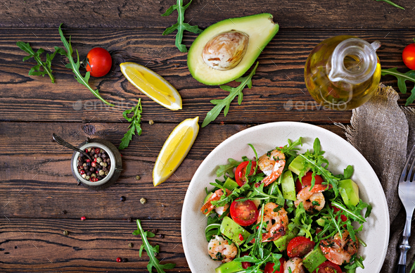 Fresh salad bowl with shrimp, tomato, avocado and arugula - Stock Photo - Images
