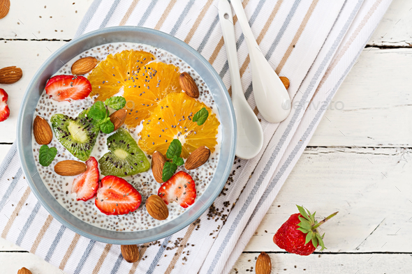 Vegan almond milk chia seeds pudding with strawberries, orange and kiwi. - Stock Photo - Images