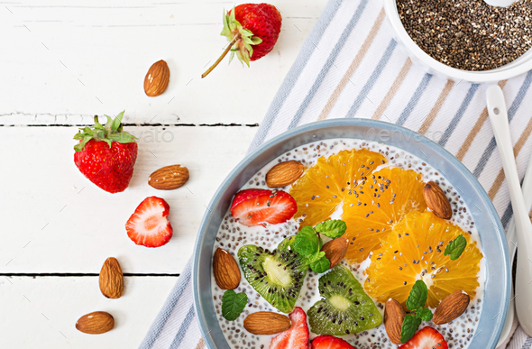 Vegan almond milk chia seeds pudding with strawberries, orange and kiwi. - Stock Photo - Images