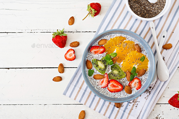 . Vegan almond milk chia seeds pudding with strawberries, orange and kiwi - Stock Photo - Images