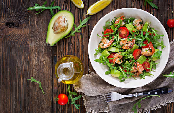 Fresh salad bowl with shrimp, tomato, avocado and arugula - Stock Photo - Images