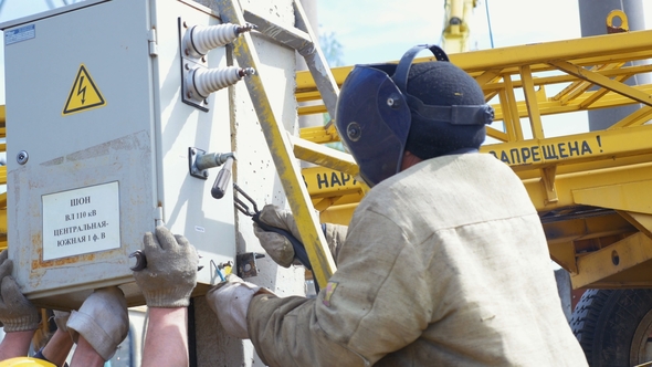 Employee Does Welding Fixing Switchboard To Concrete Bar alt
