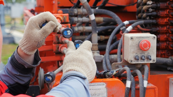 Electrician Moves Control Levers in Power Box alt