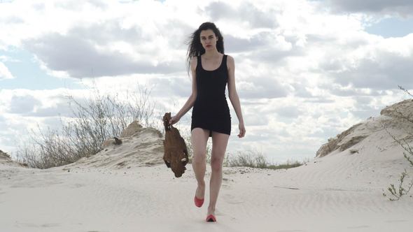 Sexy Woman with a Skull in the Desert