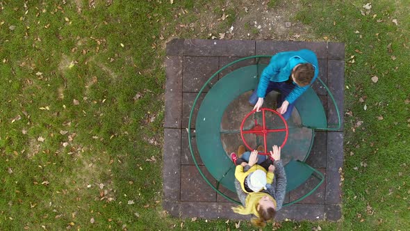 Aerial view of family spinning at merry-go-round, Zagreb, Croatia. alt