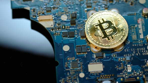 Bitcoin Mining Concept. Gold Bit Coin Lie on Circuit Board alt