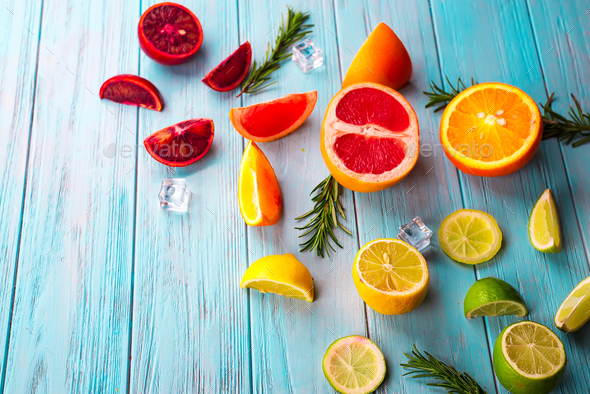 Pattern of slice citrus on blue wooden background - Stock Photo - Images