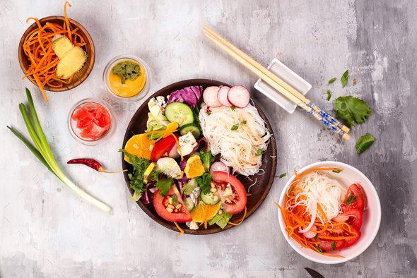 Spicy glass noodles with vegetables - carrots, cucumber, peppers, garlic. - Stock Photo - Images