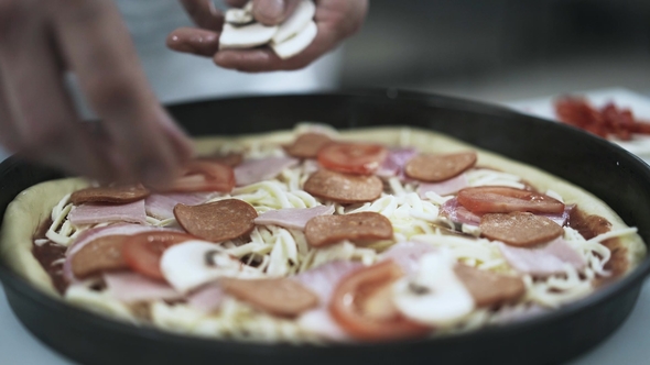 Chef Putting Mushrooms on Pizza in a Pizzeria Kitchen, Stock Footage