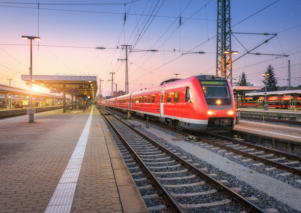 Passenger high speed train on the railway station at sunset - Stock Photo - Images
