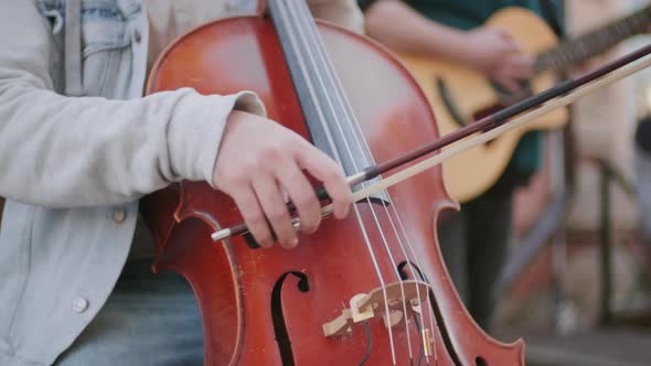 Unrecognizable Man Playing Cello Outside alt