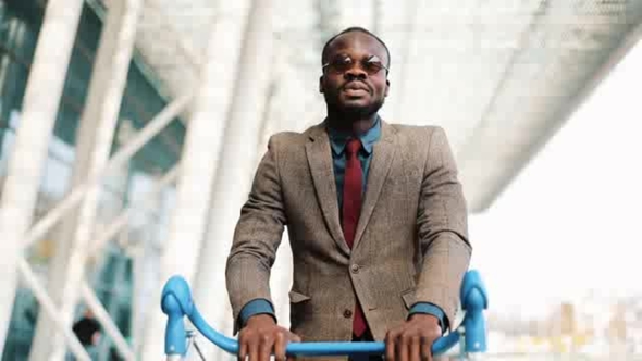 Young African American Businessman with Empty Shopping Trolley alt