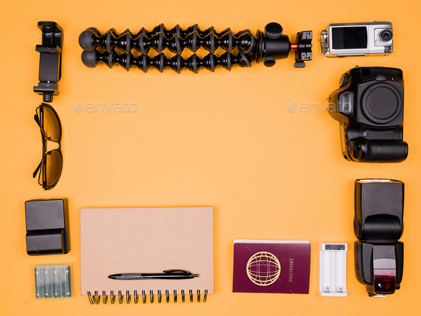 Flatlay accesories of a travel blogger on pastel orange background - Stock Photo - Images