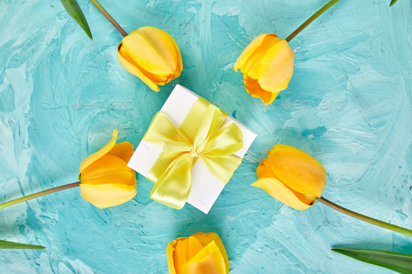 Gift box with yellow ribbon near tulip - Stock Photo - Images