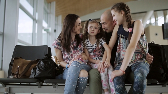 Happy Family in the Airport Lounge Waiting for Your Flight alt
