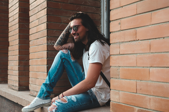 Attractive young man wearing sunglasses - Stock Photo - Images