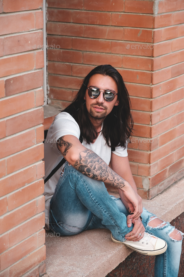 Attractive young man wearing sunglasses - Stock Photo - Images