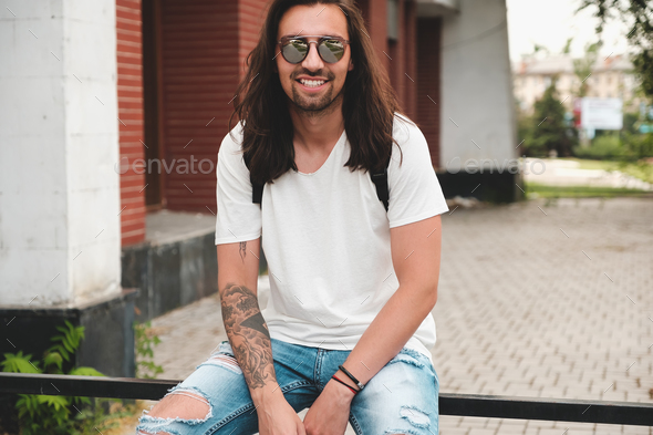 Portrait attractive man with sunglasses on urban background smil - Stock Photo - Images