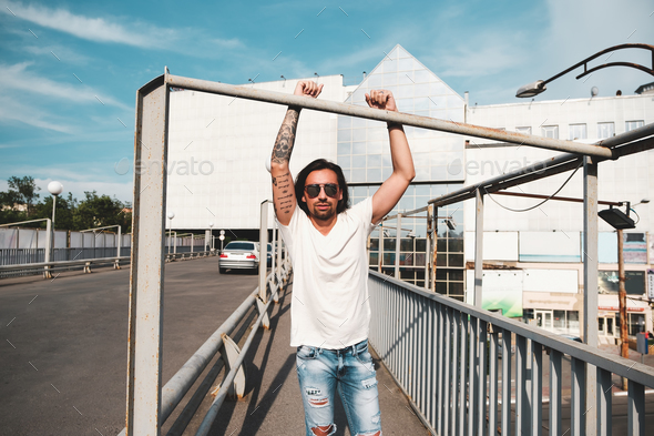 Attractive man with sunglasses hanging out in the city - Stock Photo - Images