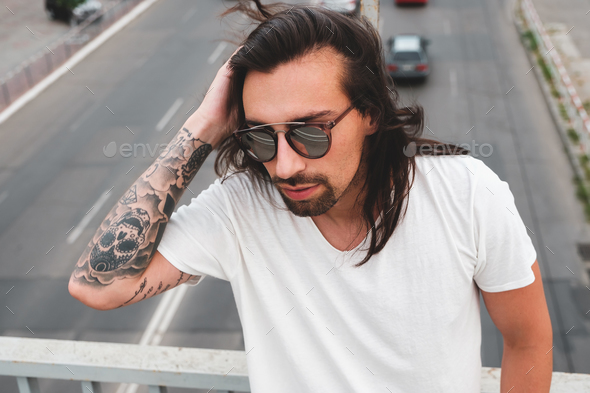 Portrait bearded stylish man touching hair - Stock Photo - Images