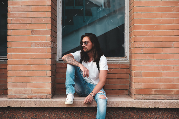 Portrait attractive man near window on urban background - Stock Photo - Images