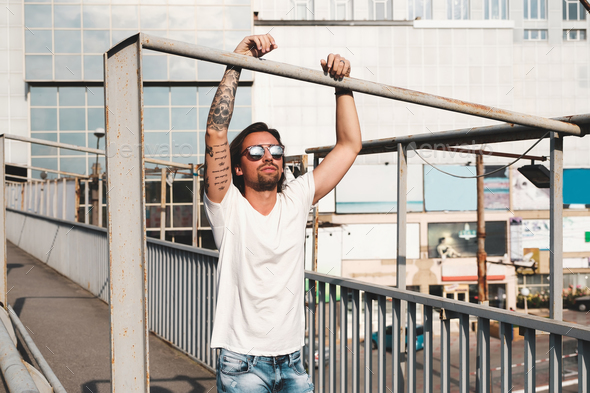 Attractive man with sunglasses hanging out in the city - Stock Photo - Images