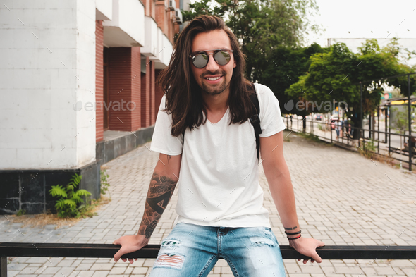 Portrait attractive man with sunglasses on urban background smil - Stock Photo - Images