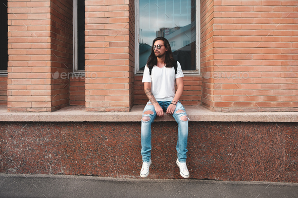 Portrait attractive man near window on urban background - Stock Photo - Images