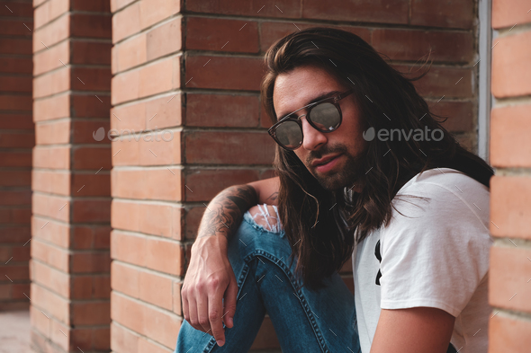 Attractive young man wearing sunglasses - Stock Photo - Images
