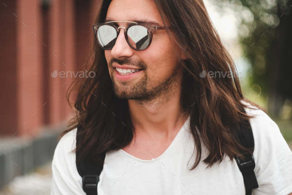 Portrait attractive man with sunglasses on urban background smil - Stock Photo - Images