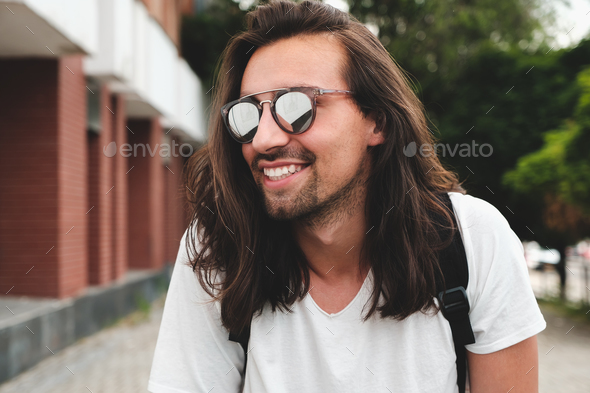 Portrait attractive man with sunglasses on urban background smil - Stock Photo - Images