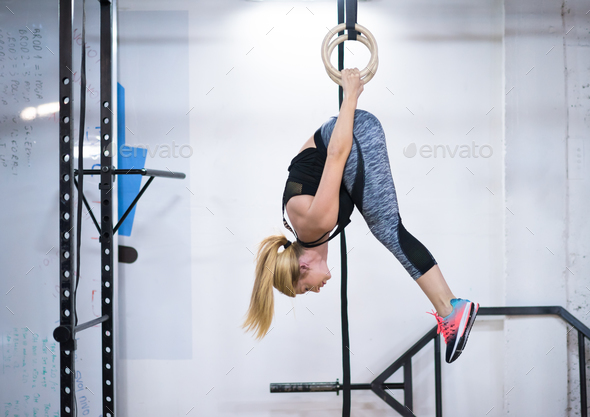 woman working out on gymnastic rings Stock Photo by dotshock