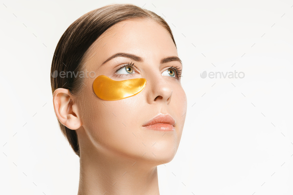 Beauty portrait of an attractive girl with a gold patch under the eye. - Stock Photo - Images