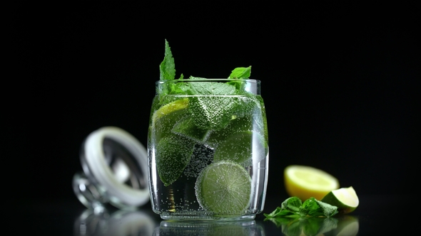 Mojito Cocktail Citrus Lemonade with Lime Lemon and Mint in Cold Sparkling Soda Water alt