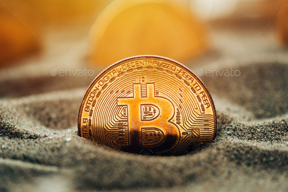 Bitcoins in sand - Stock Photo - Images