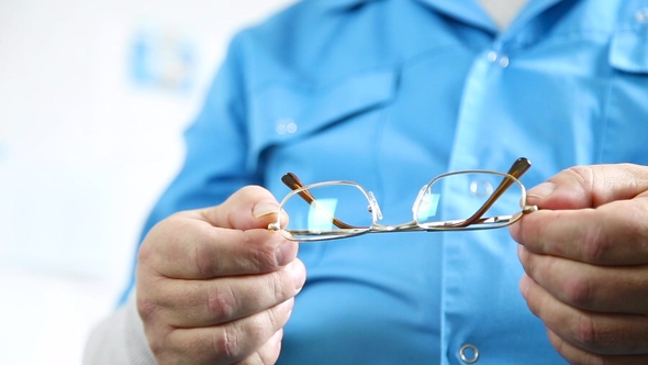 Optician Master Holding Eye Glasses alt