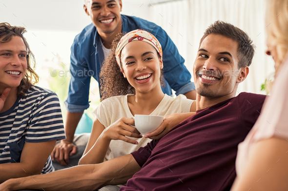 Happy young friends at home - Stock Photo - Images