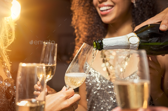 Hand pouring wine in glass - Stock Photo - Images