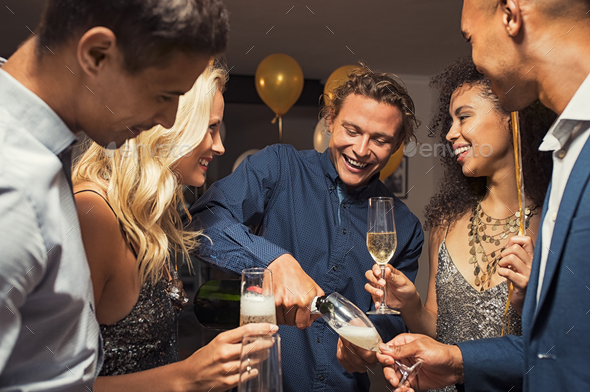 Man pouring champagne in flutes - Stock Photo - Images