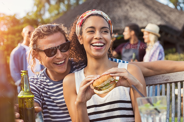 Couple enjoying food and drinks at party - Stock Photo - Images