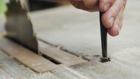 Senior Man Sets Up Woodworking Equipment alt