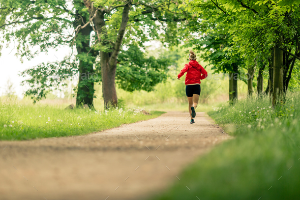 Running woman, enjoying summer day in park - Stock Photo - Images